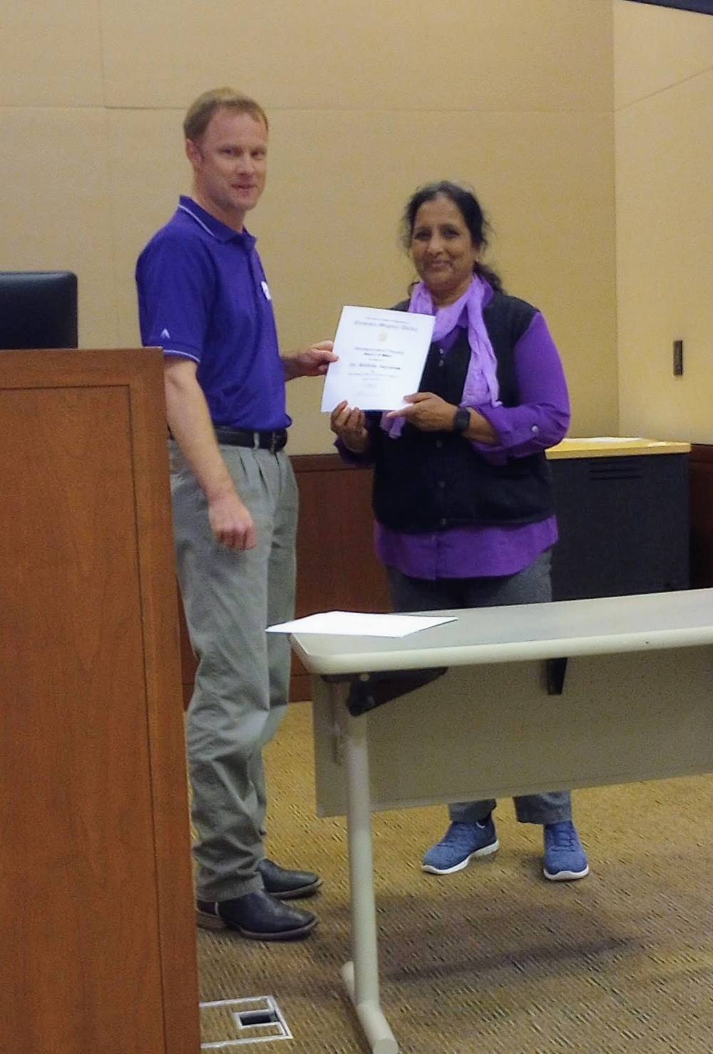 Mike Stamm presenting Distinguished Faculty award to Dr. Mithila Jugulam