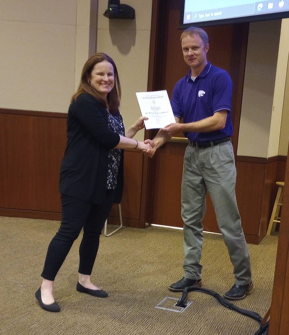 Mike Stamm presenting Early Career award to Dr. Kelsey Anderson Onofre