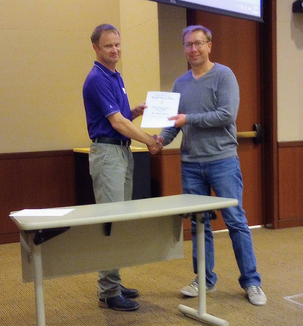 Mike Stamm presenting Outstanding Research award to Dr. Nathan Nelson